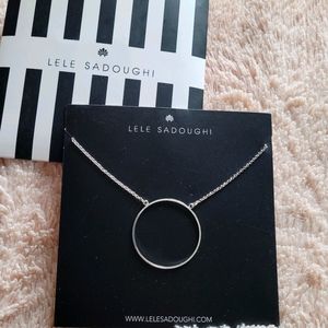 Neck with circle charm.